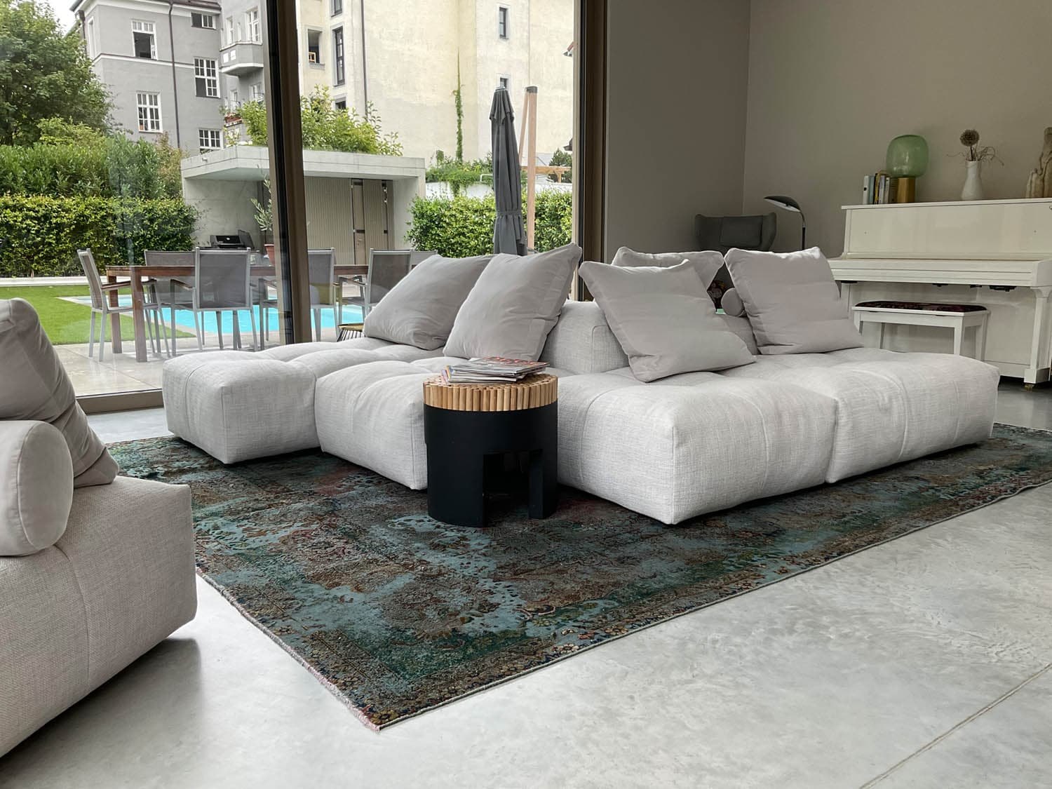 Großzügiges Wohnzimmer mit modularem Sofa und bodentiefer Verglasung